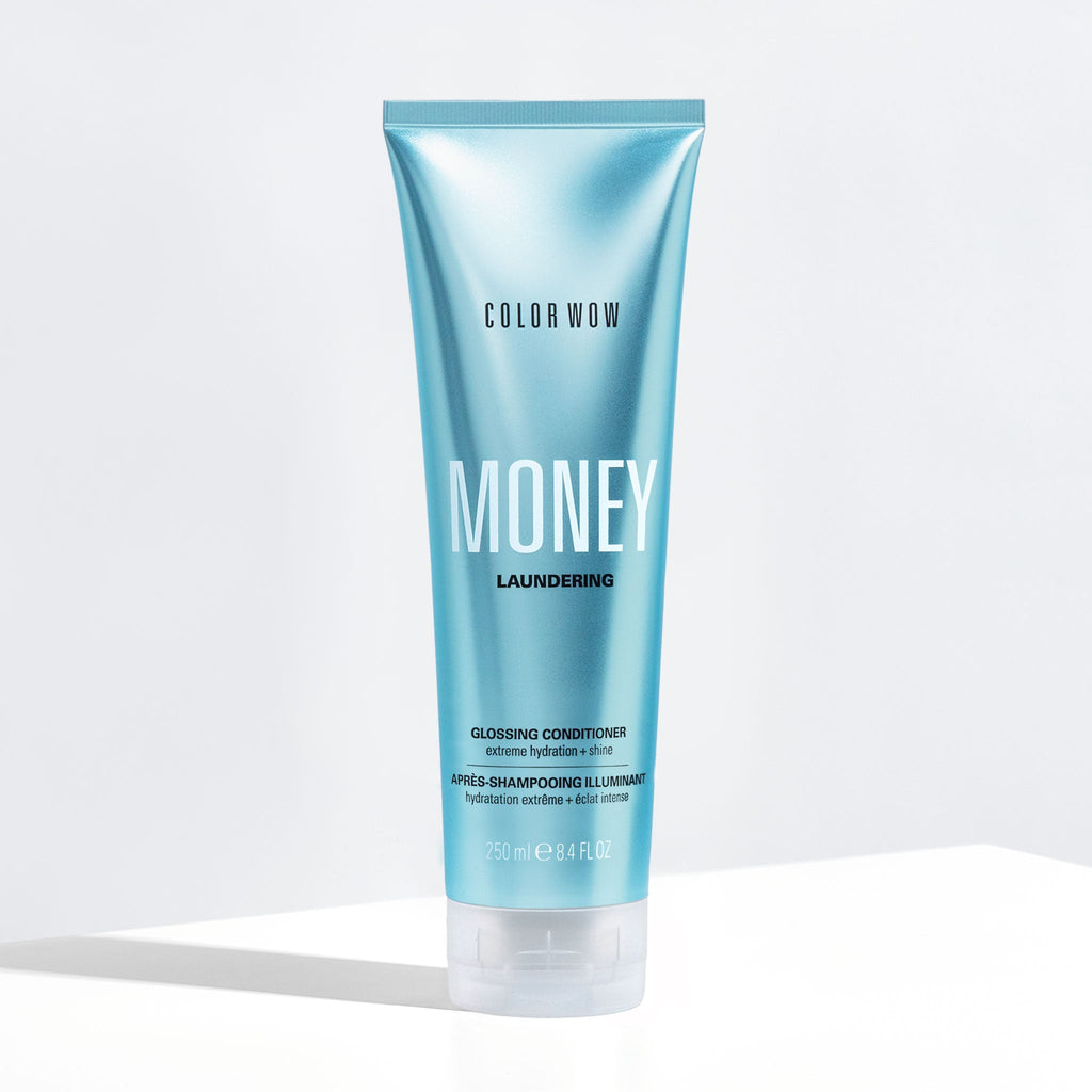 Blue shampoo bottle labeled 'Color Wow Money Laundering Glossing Conditioner' on a white background